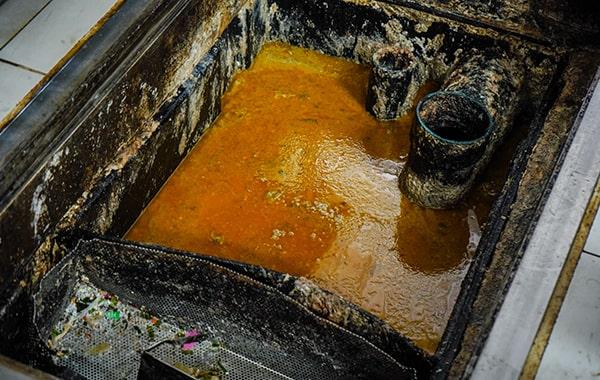 delaying grease trap cleaning can result in foul odors, clogs, and even fines for non-compliance with regulations